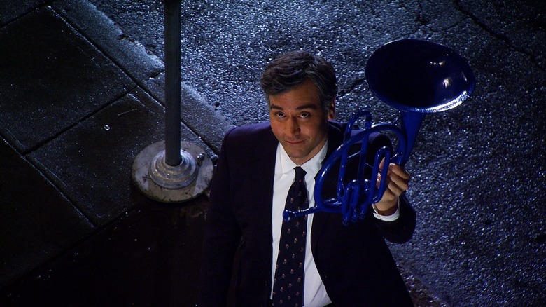 Ted holds up the blue horn