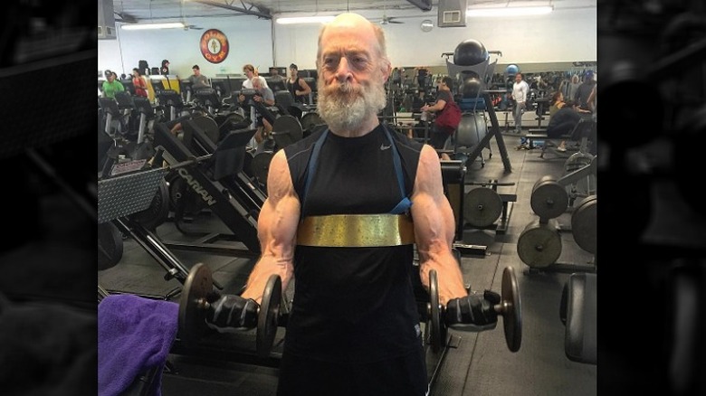 Simmons lifting weights in gym