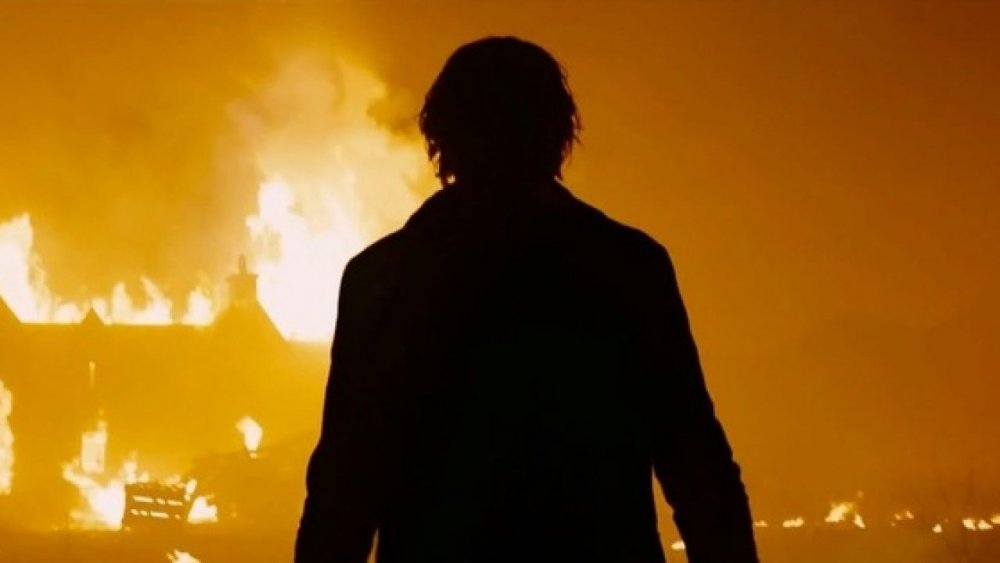 Javier Bardem watches a burning house in Skyfall