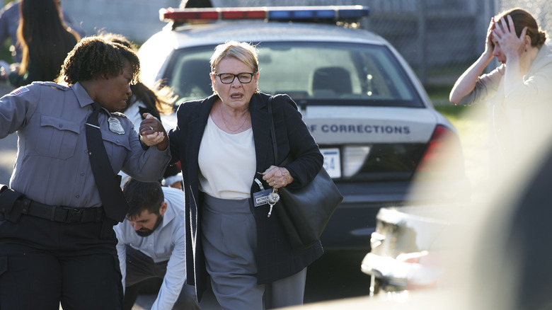 Miriam running in front of cop car