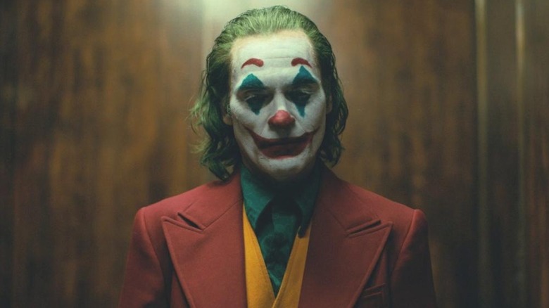 Joker wearing suit in elevator