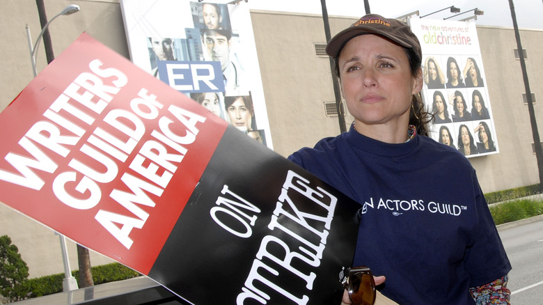 Julia Louis-Dreyfus holding a picket sign at the writer's strike in 2023