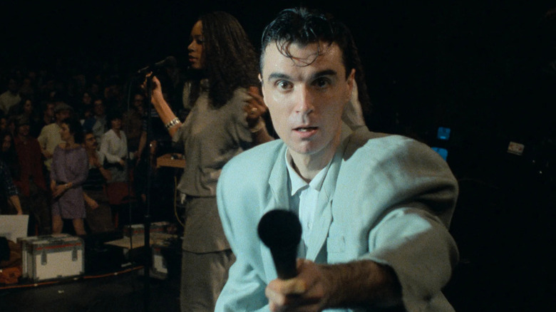 David Byrne pointing a mic at the camera in Stop Making Sense (1984)