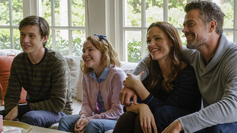 Simon, Nora, and their parents in their living room