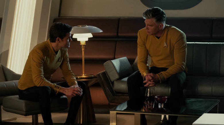 Captain Pike converses with a fellow crewmember 