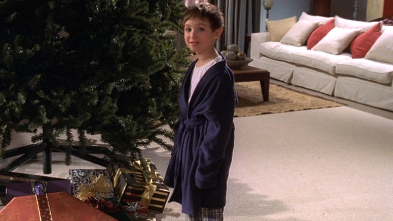 Kevin standing next to a Christmas tree wearing a robe