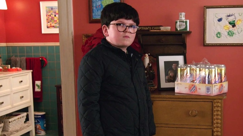 Max standing next to a crate of sodas on a chest of drawers