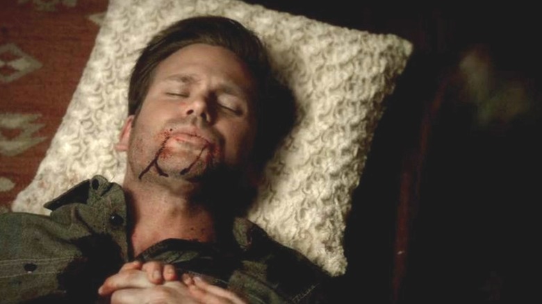 Alaric lies on the floor with blood on his mouth in "The Vampire Diaries"