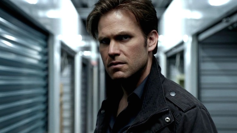 Alaric stands in the middle of storage lockers in "The Vampire Diaries"