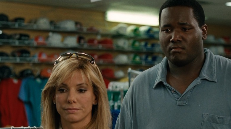 Leigh Ann Tuohy and Michael Oher standing