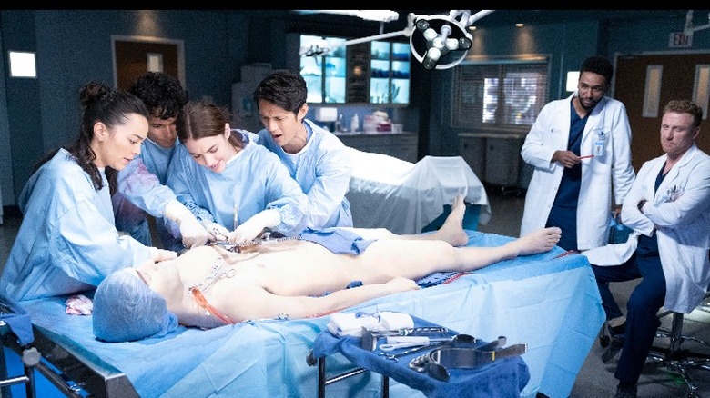 Grey's Anatomy cast members with patient-simulator mankikin