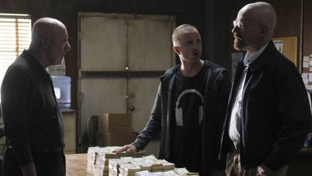 Jesse, Walt, and Mike look over their fortune on Breaking Bad