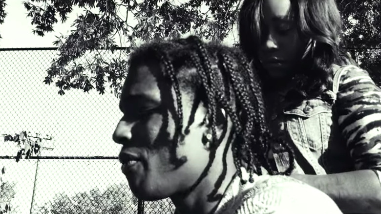 ASAP Rocky as James King with woman braiding hair