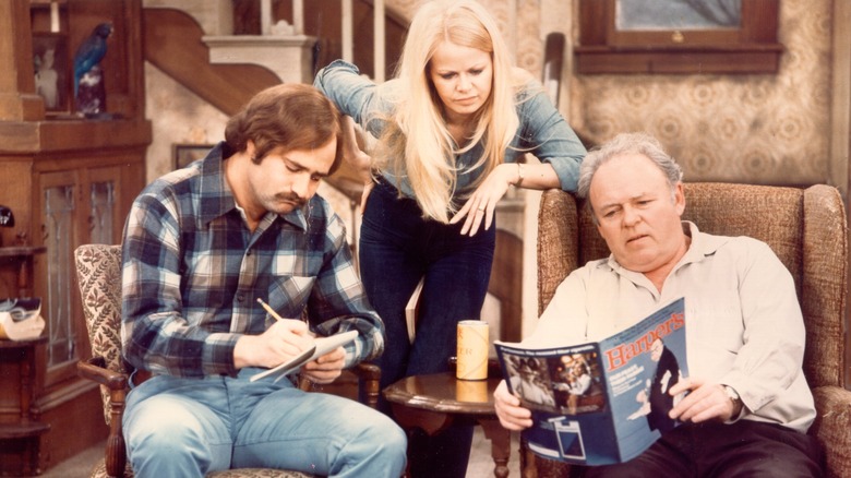 Archie Bunker holding a magazine