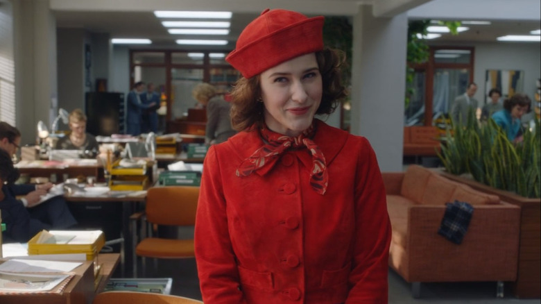 Mrs. Maisel smiling in office