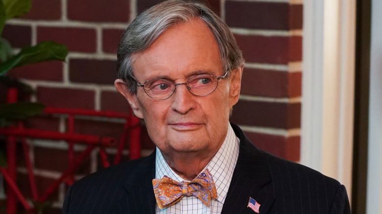 Dr. Ducky Mallard wearing glasses, orange bowtie and flagpin,