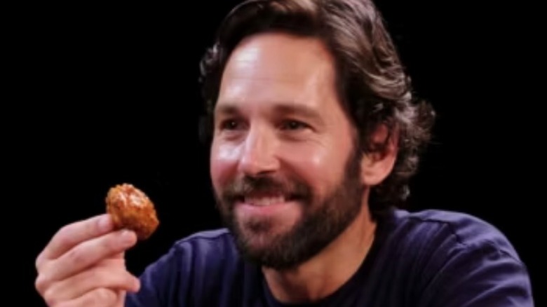 Paul Rudd holds up a wing