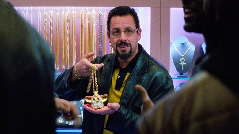 Howard holding up gold Furby chain