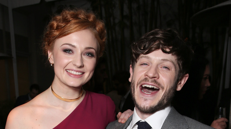 Sophie Turner and Iwan Rheon smiling together