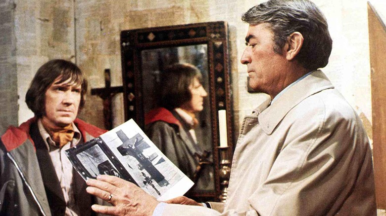 Gregory Peck holding book in The Omen