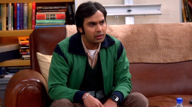 Raj Koothrappali sitting on couch looking serious