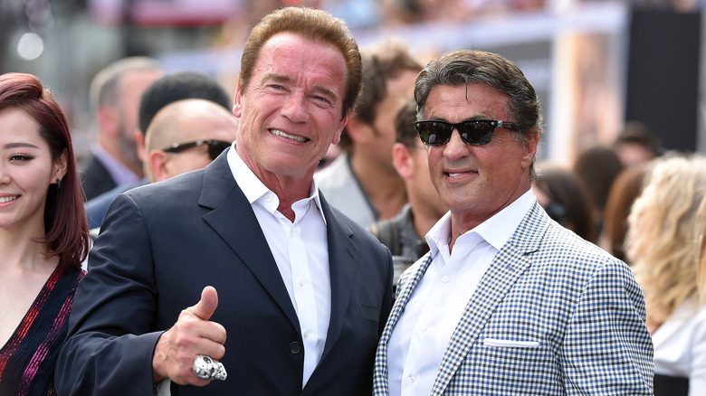 Arnold Schwarzenegger and Sylvester Stallone smiling