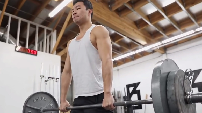 Simu Liu deadlifting in gym