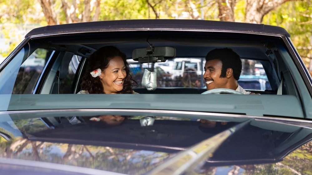 Ata and Rocky Johnson smiling in car