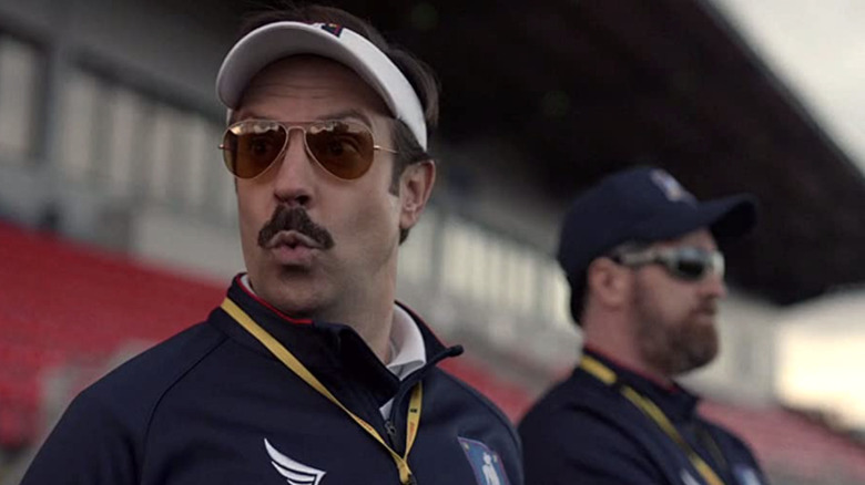 Jason Sudeikis wearing sunglasses on Ted Lasso