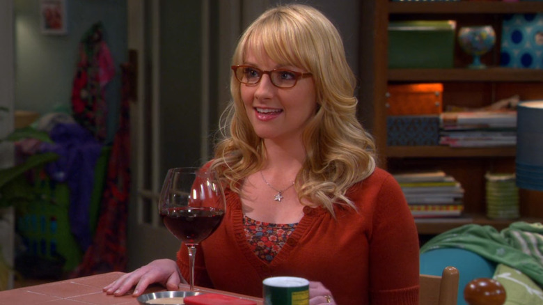 Bernadette drinking wine at table