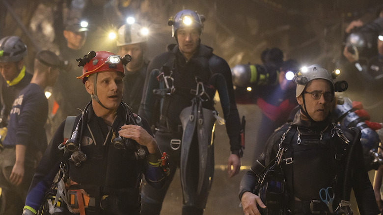 Divers walking in cave in Thirteen Lives