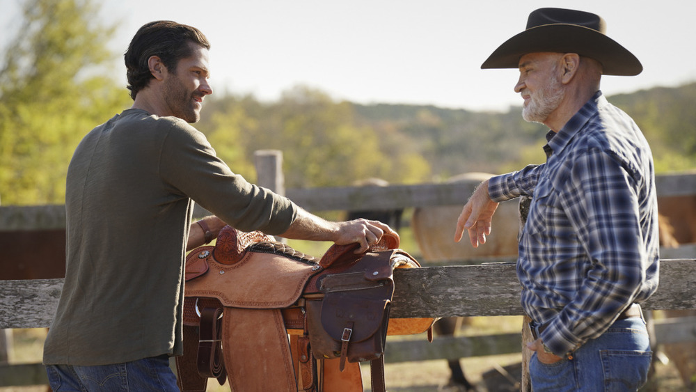 Cordell chatting with his dad while picking up a saddle