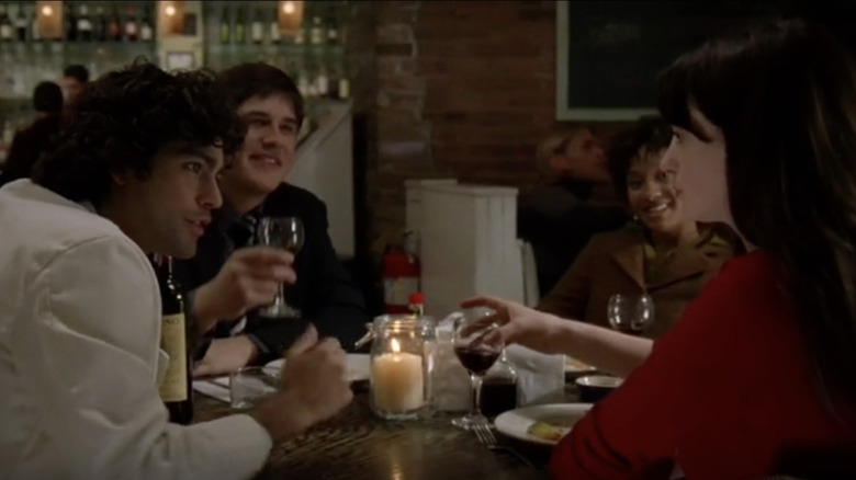 Friends sharing dinner in The Devil Wears Prada