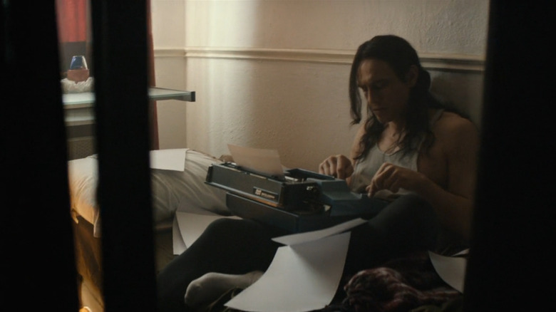 James Franco as Tommy Wiseau typing on a typewriter