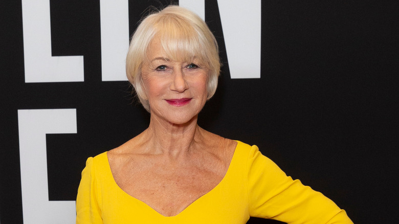 Helen Mirren smiling in yellow top