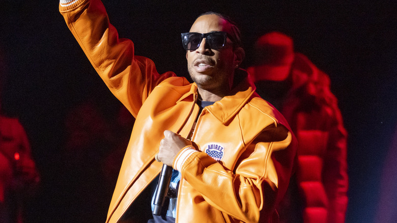 Ludacris performing in orange jacket