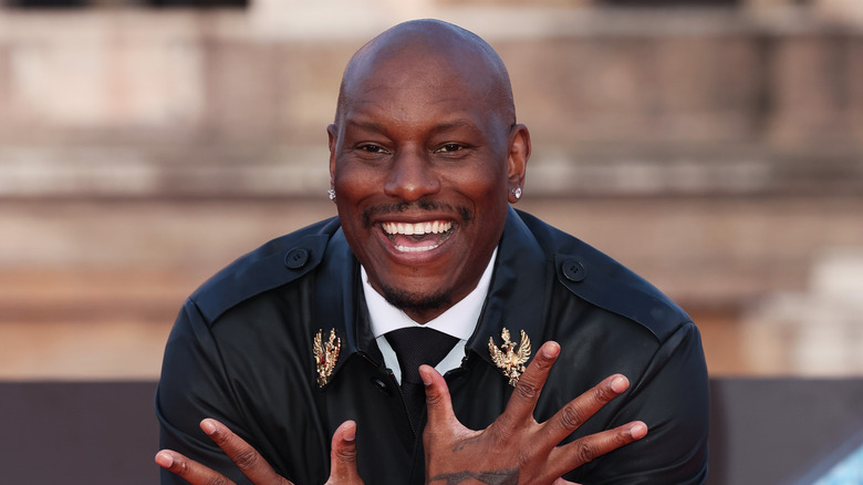 Tyrese Gibson smiling in suit and coat