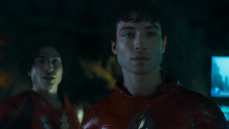 Two Barry Allens wearing Flash costumes in Batcave