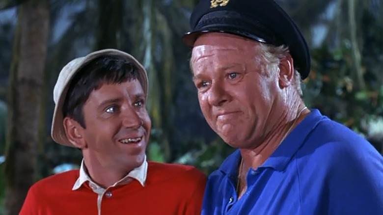 Bob Denver and Alan Hale smiling together in a scene from Gilligan's Island