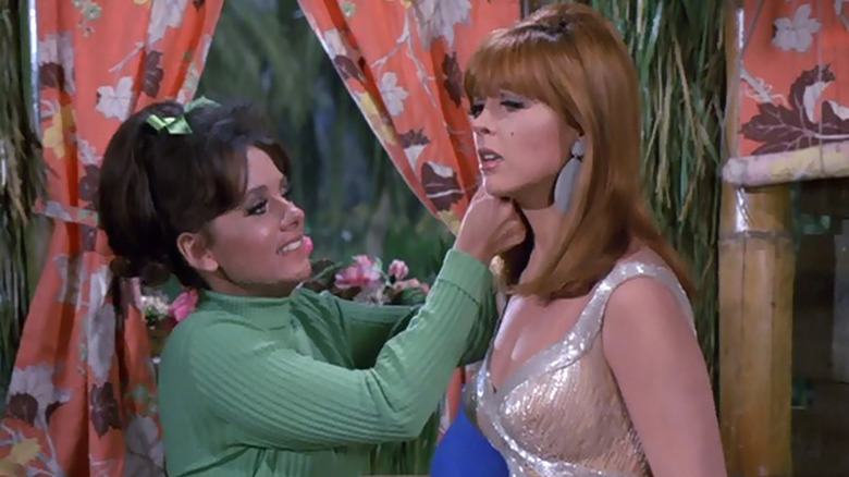 Dawn Wells and Tina Louise playing dress up in a scene from Gilligan's Island