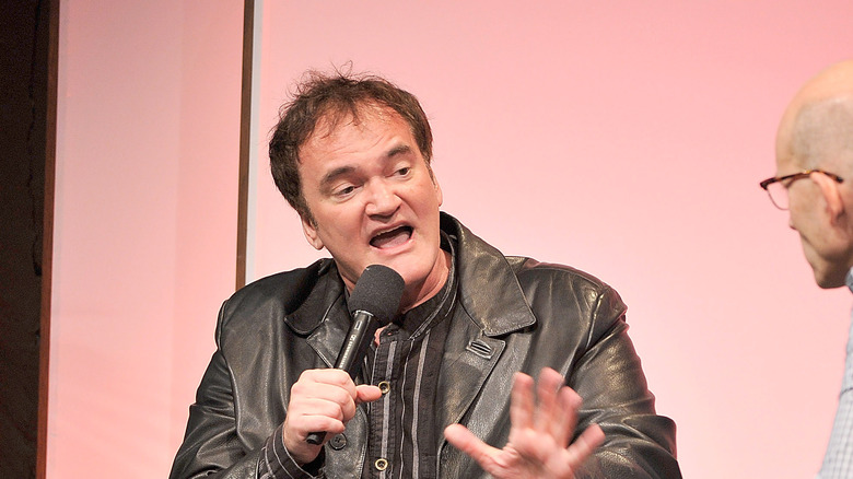 Tarantino talking into microphone