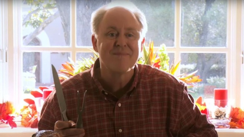 Mitchell smiling with knife in hand