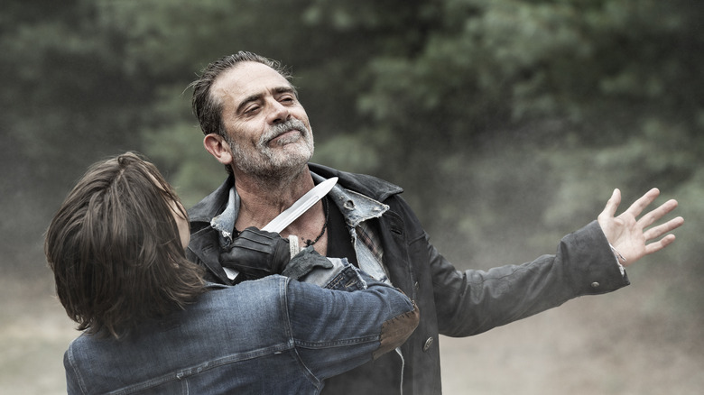 Maggie holds a knife to Negan's throat