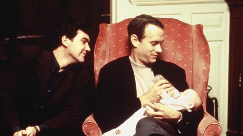 Tom Hanks feeding a baby