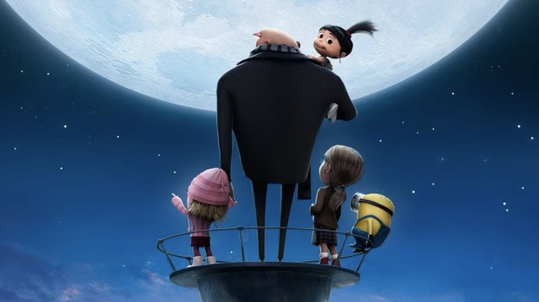 Gru and his adoptive daughters look up longingly at the moon