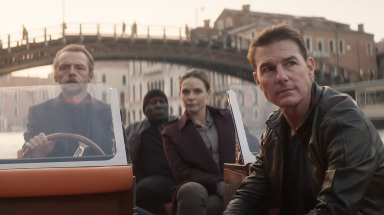 Benji, Luther, Ilsa, and Ethan Hunt sitting in boat