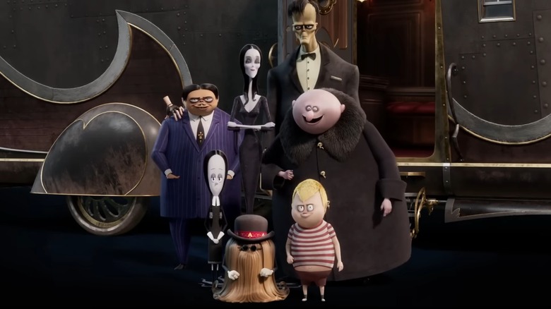 Addams family posing for photo in front of camper (2021)