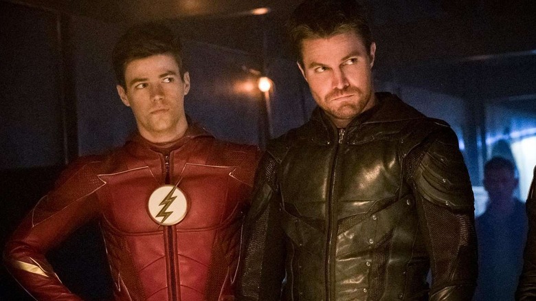 Oliver Queen and Barry Allen standing together unmasked in Arrow