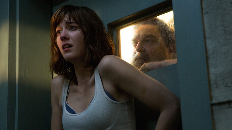 Michelle cowers from Howard behind a bunker door in "10 Cloverfield Lane" (2016)