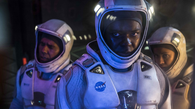 Three frustrated astronauts wearing space suits in "The Cloverfield Paradox" (2018)